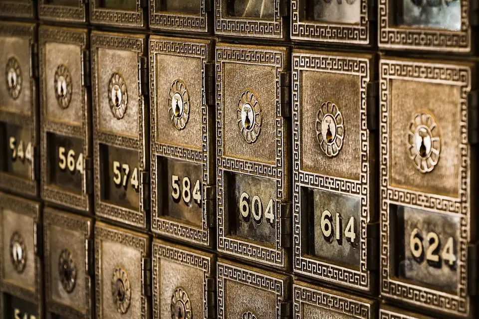 Rows of ornate brass post office boxes, each with a small window and a number from 544 to 624